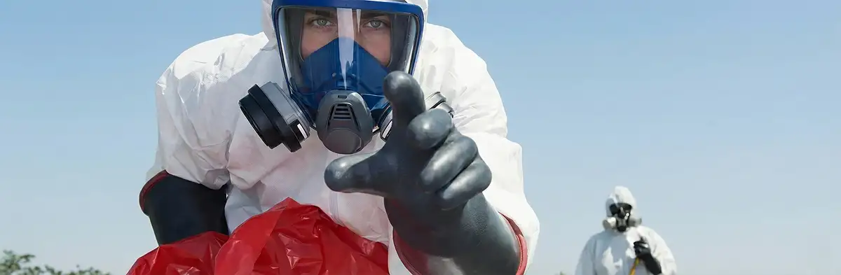sewage clean up technician wearing protective gear handling biohazard materials in Raleigh, NC