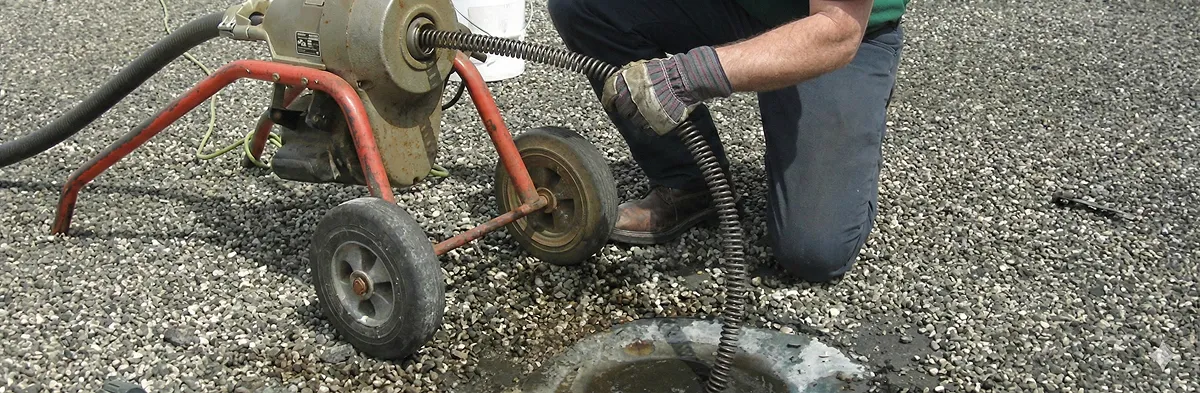 sewer rodding technician actively removing blockages from a sewer line in Raleigh, NC