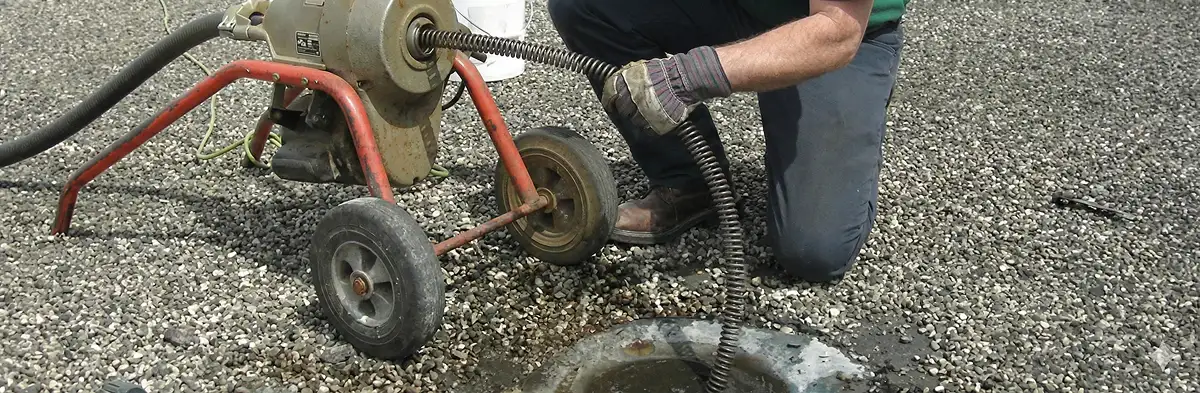 sewer rodding technician actively removing blockages from a sewer line in Raleigh, NC