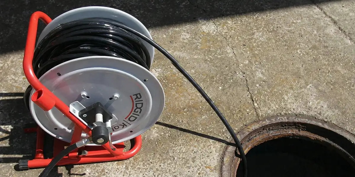 sewer rodding equipment prepared to clear clogged sewer lines in Raleigh, NC