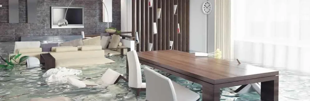 home interior affected by water damage with flooded floors and displaced furniture in Raleigh, NC